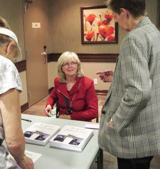 Maureen selling copies of her book after the presentation.