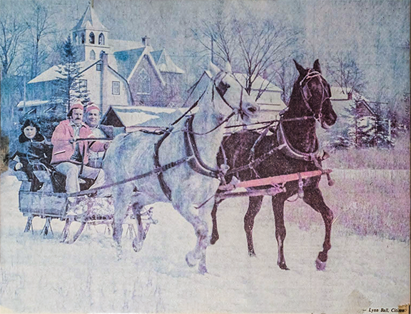 This picture, titled "Rural Christmas" appeared in the Ottawa Citizen on December 26, 1975. The full caption read, "Dashing through the snow in a two-horse open sleigh is as much fun as the one-horse kind as Tom Panagiotopouas and his son Mike discover. Keeping a tight rein on the team is Morris (Sundance Kid) Smith of Manotick." Clearly visible in the background is Manotick United Church.