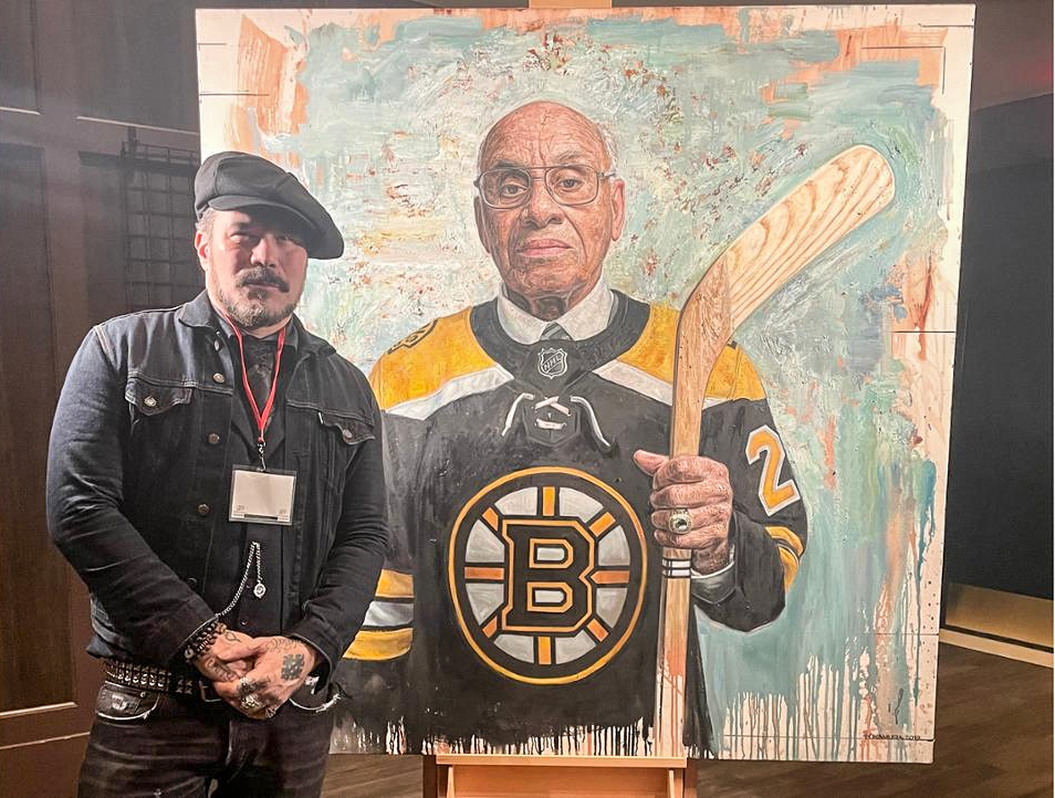 Artist Tim Nokamura with his portrait of Willie O'Ree, unveiled at the Beaverbrook Gallery in Fredericton
